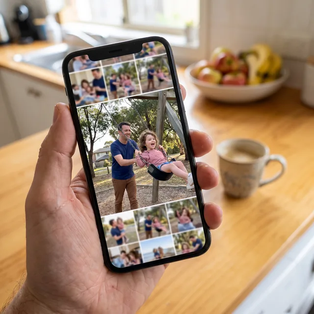 A hand holding a phone with family photos on the screen, the biggest one a dad pushing his daughter on a swing